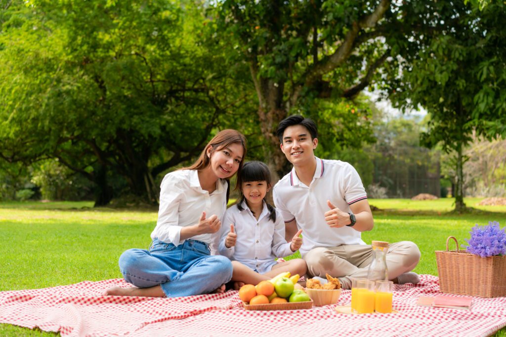 Family is enjoying a picnic time on summer holidays-Cyboard school