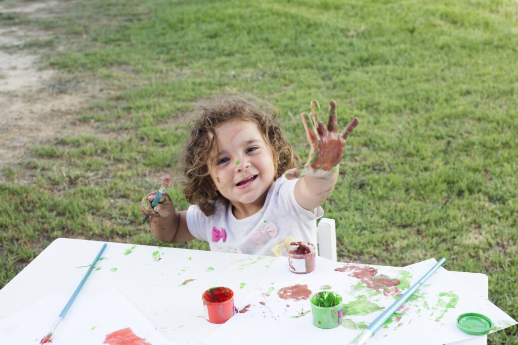 Cute girl is doing hands painted -Cyboard School