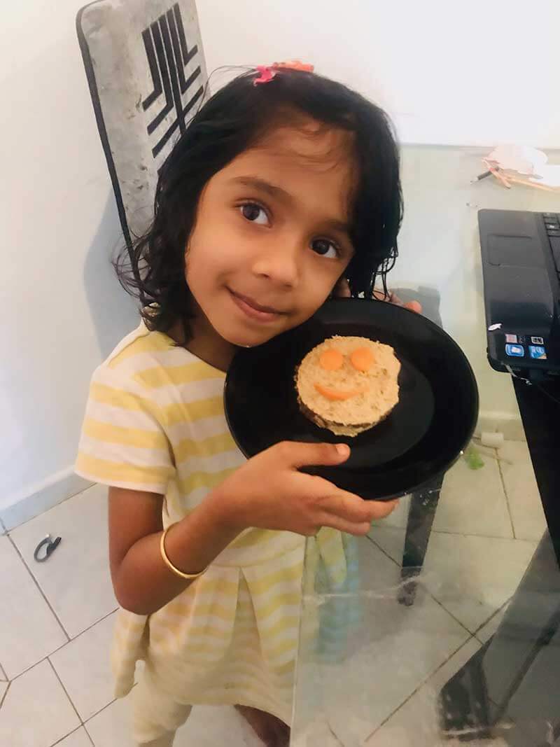 Student of Cyboard School is preparing a sandwich for a kitchen activity