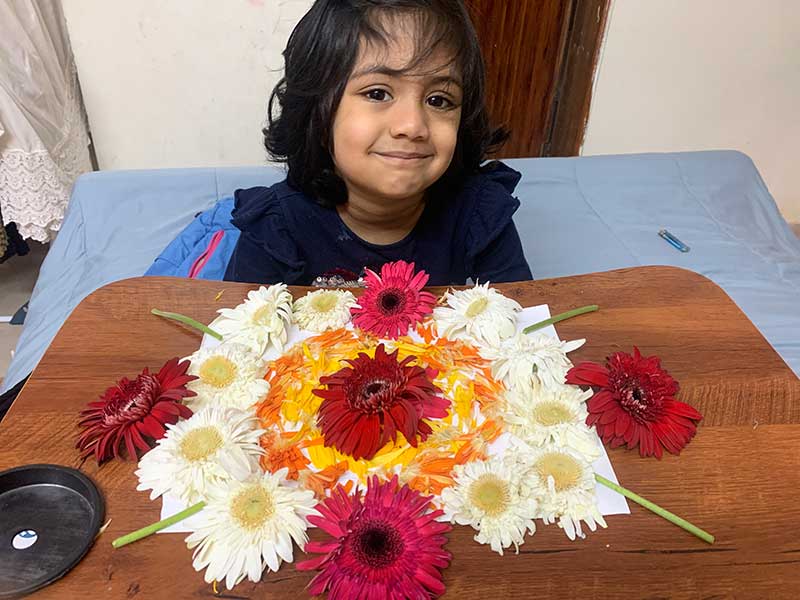 Student of Cyboard School is preparing a rangoli with flowers