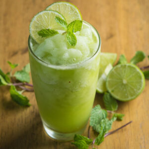 refreshing mint lime slushie with crushed ice served as a healthy summer drink for kids.