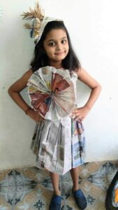 She is wearing a newspaper dress for Cyboard School activity