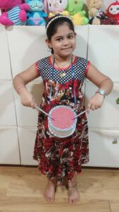 A Student of Cyboard School is Playing a drum