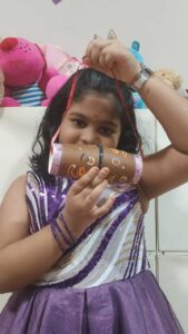 She is preparing something with a cardboard for a cyboard school activity