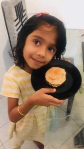 Student of Cyboard School is preparing a sandwich for a kitchen activity