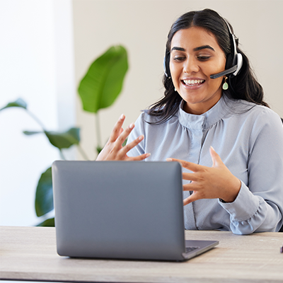 Woman participating in online meeting with headset