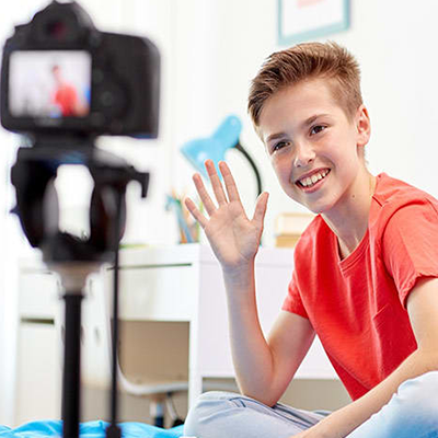 A smiling kid sitting in front of camera - Content creation