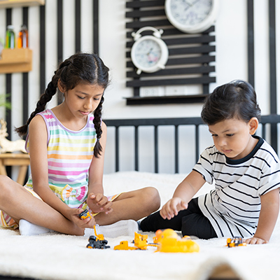 Children enjoying indoor activities for kids like storytelling, memory games, and word challenges at home
