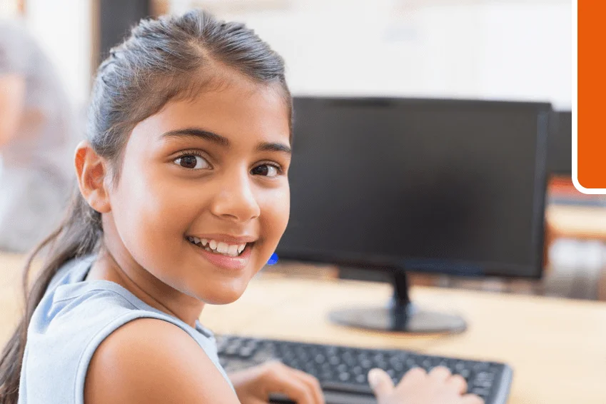 Kid working on computer in online school